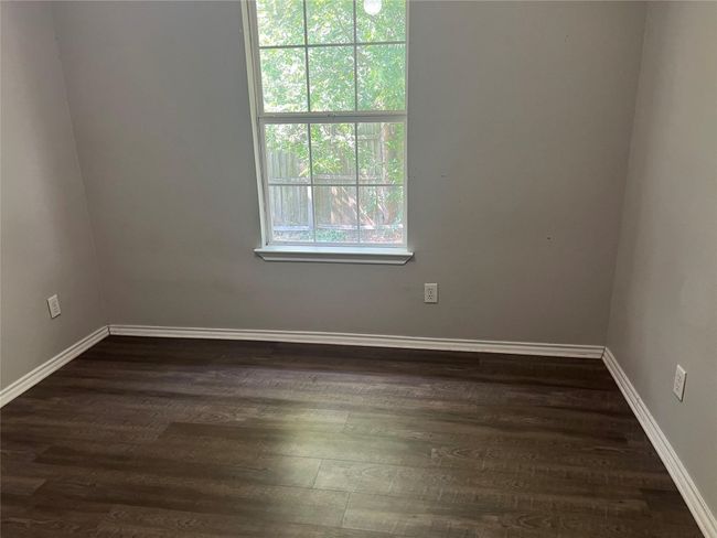 Unfurnished room featuring baseboards and dark wood-style floors | Image 8