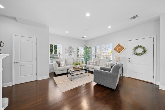 Living room featuring baseboards, wood finished floors, recessed lighting, and plenty of natural light | Image 7