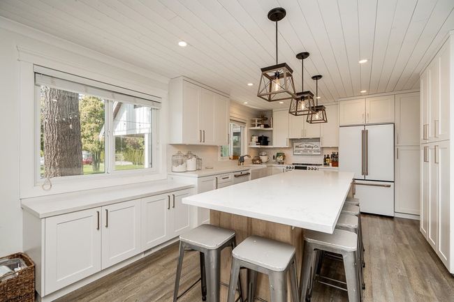 Kitchen with wood ceiling, high end refrigerator, recessed lighting, and dark wood-style floors | Image 5