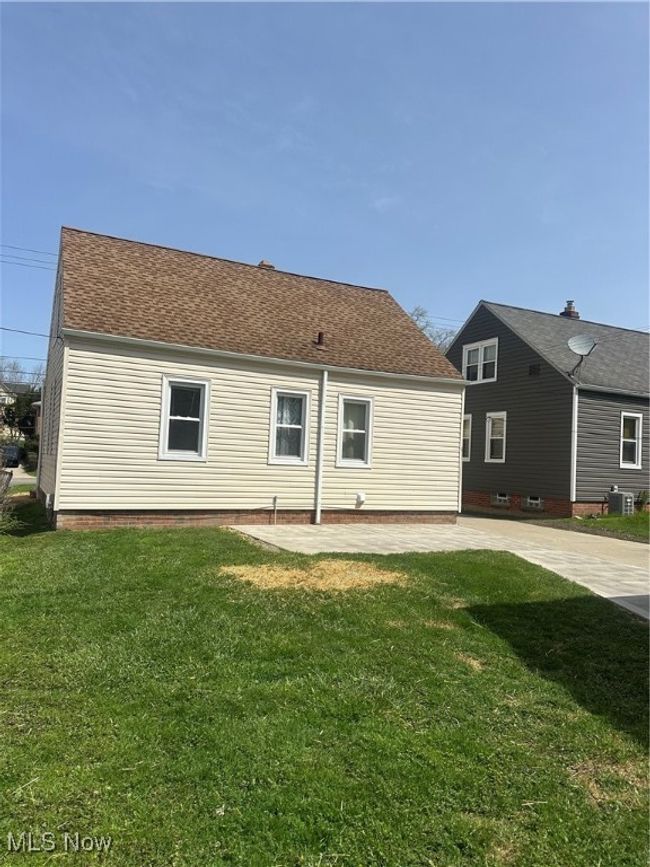 Rear view of house featuring a lawn and roof with shingles | Image 7