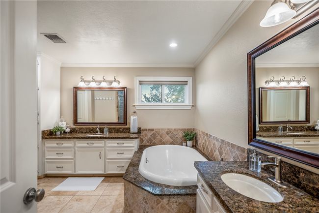 Full bathroom featuring crown molding, visible vents, and a sink | Image 36