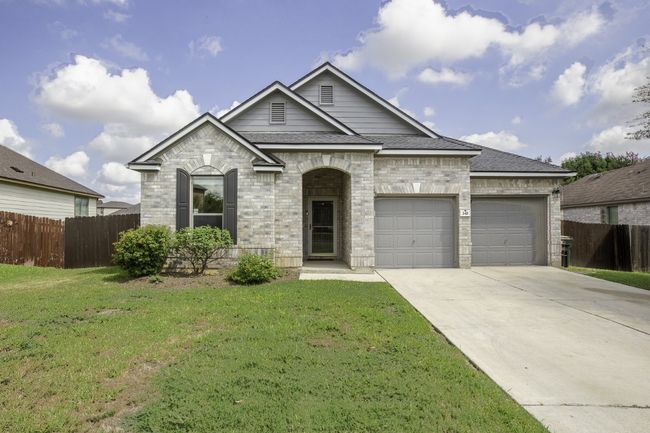 French country inspired facade with an attached garage, concrete driveway, roof with shingles, and brick siding | Image 5