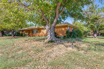 Ranch-style house with spacious front lawn | Image 1