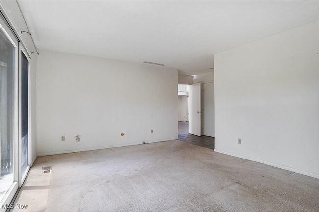 Empty room featuring visible vents, baseboards, and light carpet | Image 29