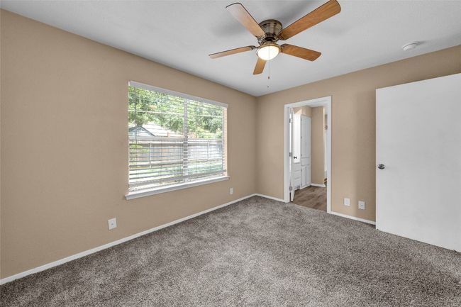 Unfurnished bedroom featuring baseboards, carpet floors, and a ceiling fan | Image 12