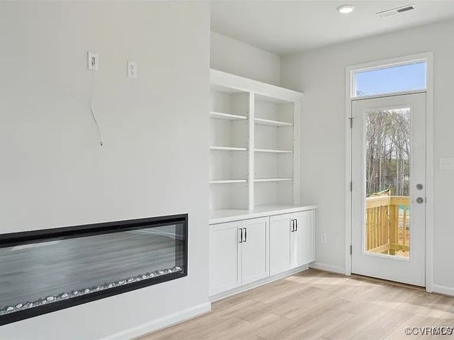 Unfurnished living room featuring light wood-style flooring and recessed lighting | Image 17