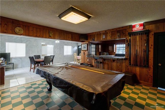 Rec room featuring wooden walls, pool table, and a textured ceiling | Image 28