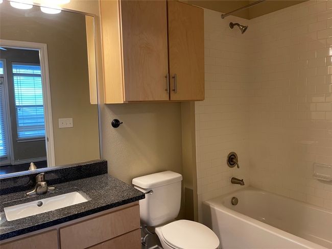 Bathroom featuring vanity and washtub / shower combination | Image 23