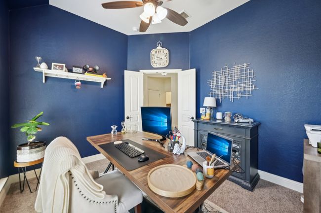 Office with carpet, visible vents, baseboards, and ceiling fan | Image 16