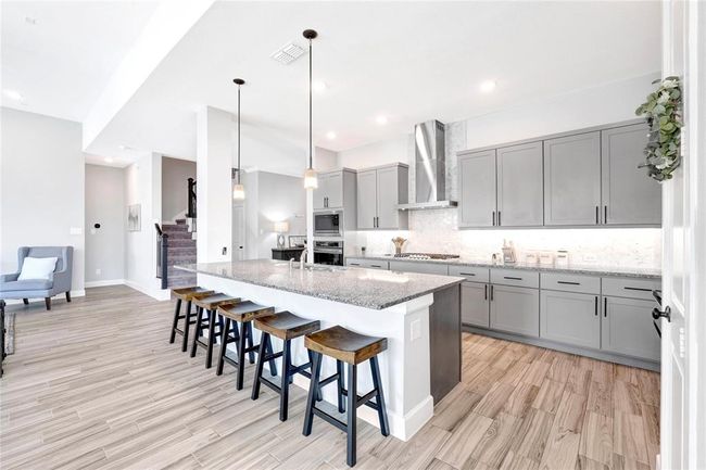 Upgraded gourmet kitchen with island seating | Image 17