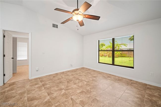 Unfurnished room with healthy amount of natural light, ceiling fan, and high vaulted ceiling | Image 24