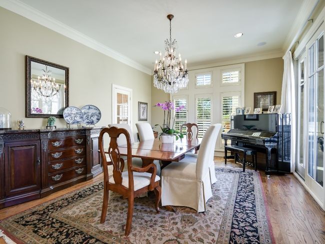 Dining room featuring a chandelier, wood finished floors, crown molding, and recessed lighting | Image 6