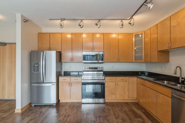 You could add in a dining table in this spacious kitchen. (The photos are of unit 401. Owned by the same person and finishes that are VERY similar) | Image 5