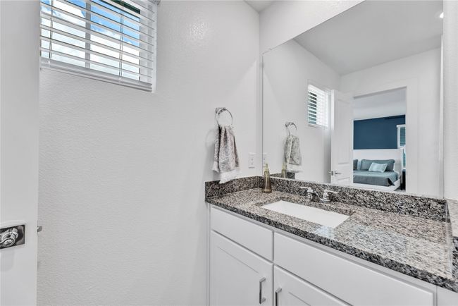 Bathroom featuring a textured wall, vanity, and ensuite bathroom | Image 22