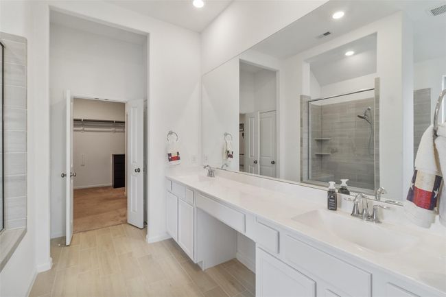 A spacious primary bathroom with double vanities and plenty counter space is perfect for getting ready each day. | Image 25