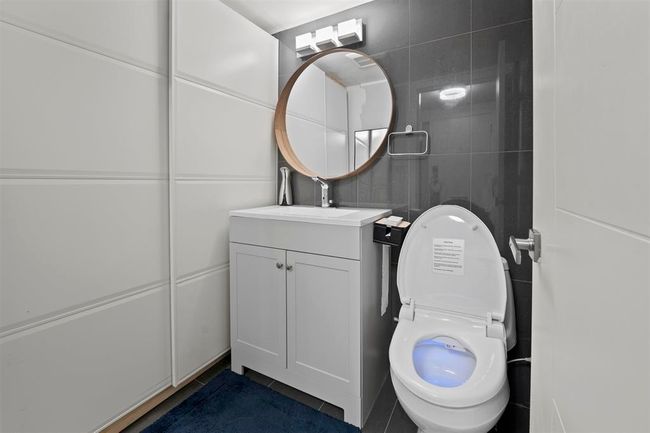 Half bath with vanity, toilet, and tile patterned flooring | Image 11