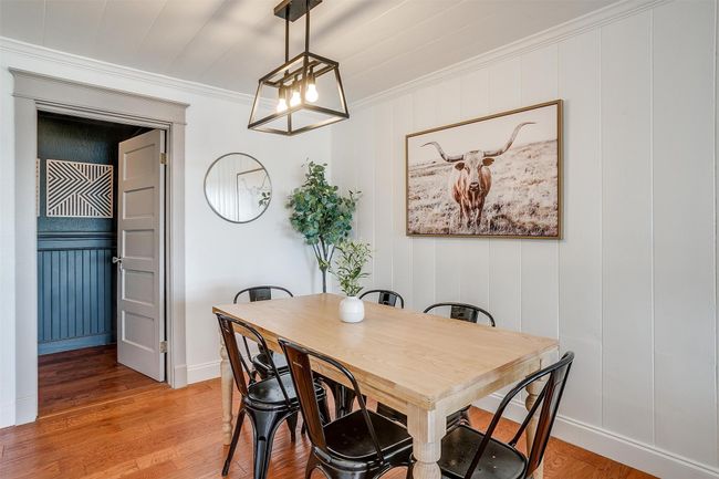 Dining area with ornamental molding, light wood-type flooring, baseboards, and a chandelier | Image 18