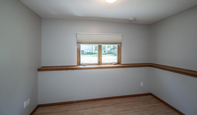Fourth bedroom with oak wall ledges, overhead lighting & windows to back. | Image 32