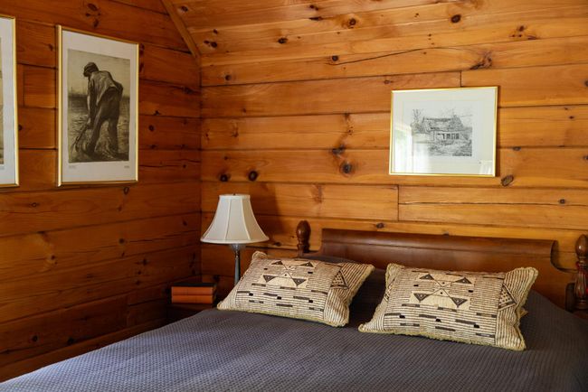 Bedroom featuring wooden walls, vaulted ceiling, and carpet floors | Image 18