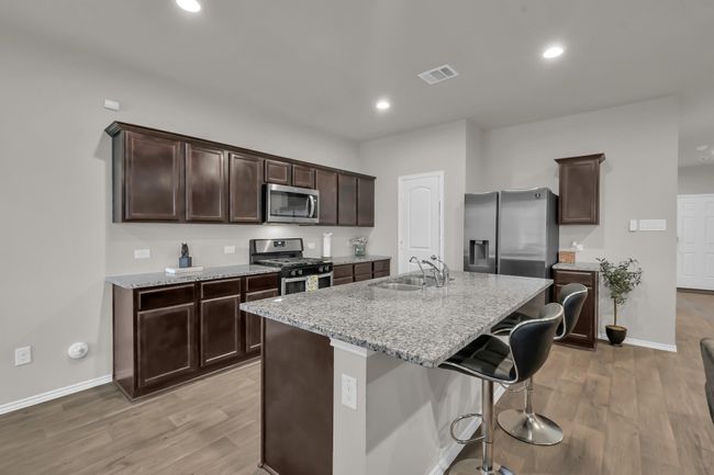Notice the HUGE kitchen island taking center stage. It’s the perfect spot for quick breakfasts, casual meals, or setting up a buffet line! | Image 11