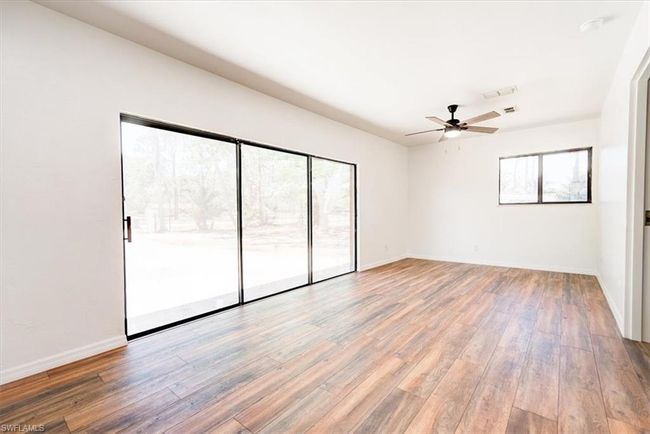 Unfurnished room featuring baseboards, wood finished floors, and a ceiling fan | Image 33