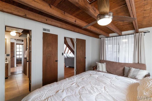 Bedroom featuring beam ceiling, visible vents, wooden ceiling, and light tile patterned floors | Image 28