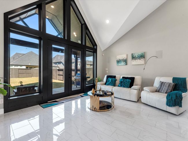 The layout, with beautiful windows, vaulted point ceiling and warm tones encase a great family area with the open view of extended patio an huge backyard for pleasure and entertaining | Image 16