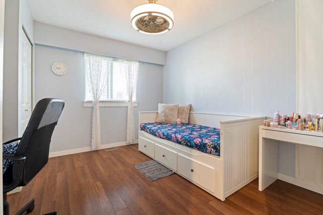 Bedroom featuring wood finished floors and baseboards | Image 19
