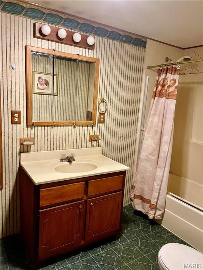 Full bathroom with vanity, toilet, crown molding, and shower / tub combo with curtain | Image 10