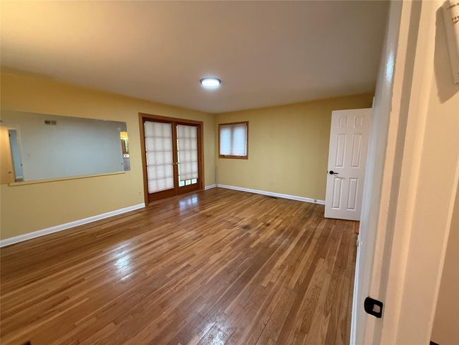 Unfurnished room featuring french doors, baseboards, and hardwood / wood-style floors | Image 10
