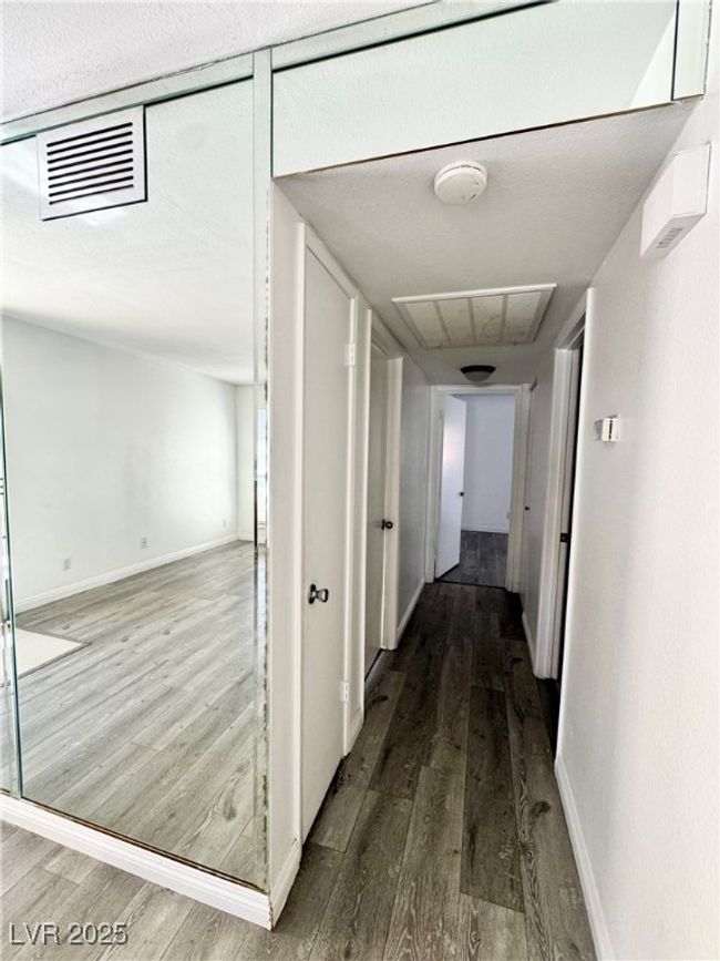 Hallway featuring wood finished floors and a textured ceiling | Image 11
