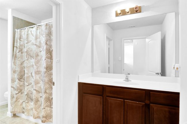 Full bath with vanity, a shower with curtain, tile patterned flooring, visible vents, and toilet | Image 18