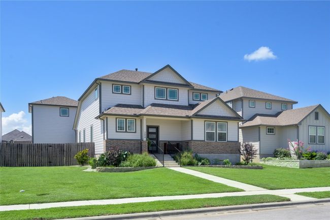 Craftsman-style house with roof with shingles and brick siding | Image 25