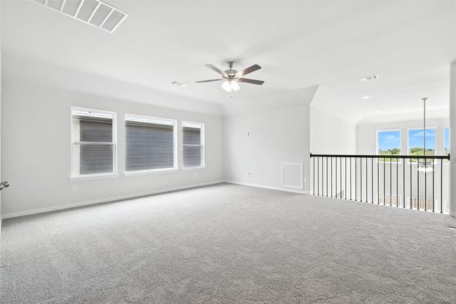 Carpeted empty room with ceiling fan and baseboards | Image 25