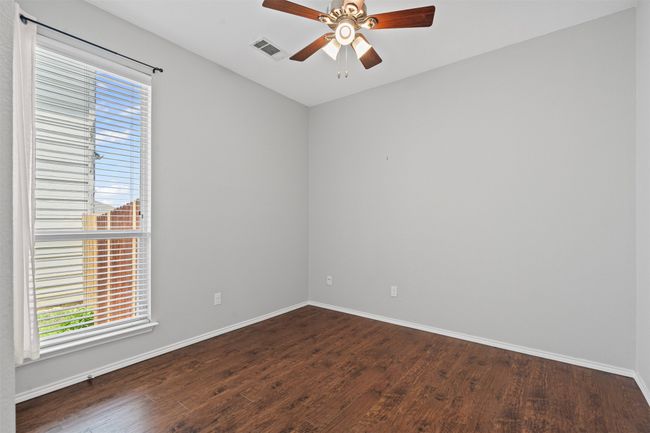 Empty room with a ceiling fan, healthy amount of natural light, and dark wood finished floors | Image 10