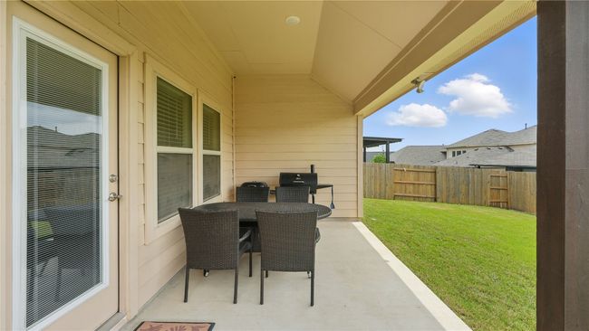 Fenced backyard featuring a patio area, outdoor dining space, and grilling area | Image 35