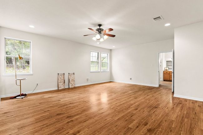 Unfurnished room featuring visible vents, light wood-style flooring, a ceiling fan, and baseboards | Image 22