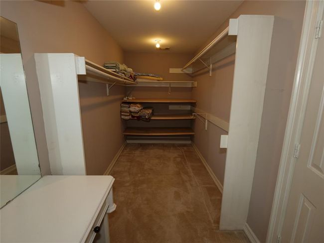 One of the his/her primary walk-in closet | Image 38
