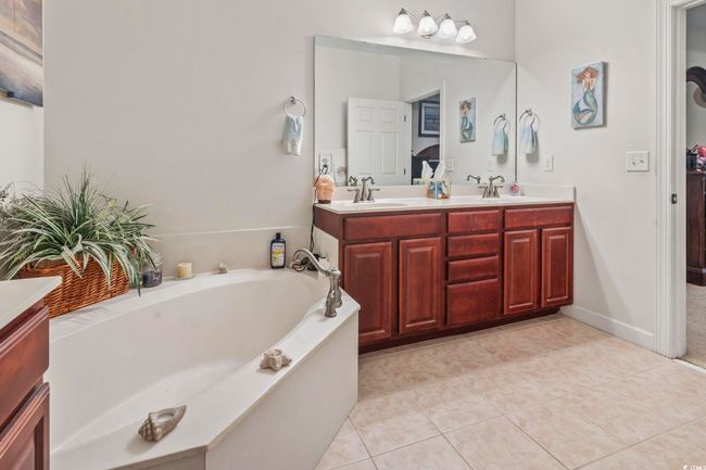 Full bathroom featuring double vanity, a garden tub, and tile patterned flooring | Image 14