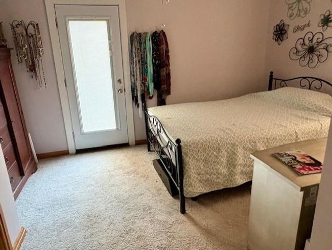 Bedroom featuring baseboards and light carpet | Image 25