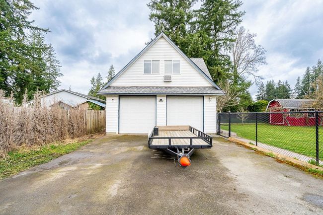 Detached garage featuring fence | Image 26