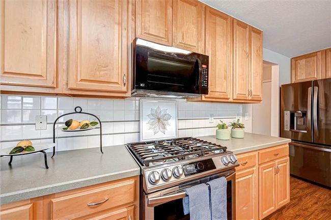 Gas range and microwave hood make cooking a breeze. | Image 15