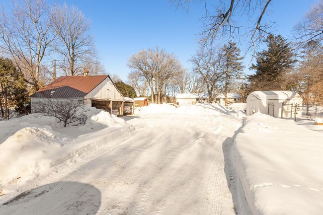 Covered parking for 3 vehicles. Large shed with fenced kennel area | Image 43