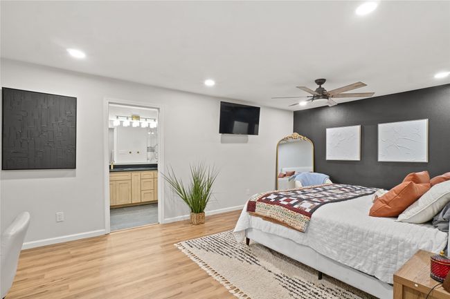 Bedroom with recessed lighting, light wood finished floors, ensuite bathroom, and a ceiling fan | Image 16