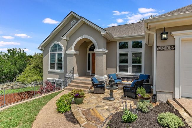 Property entrance with roof with shingles, stucco siding, and a patio | Image 5