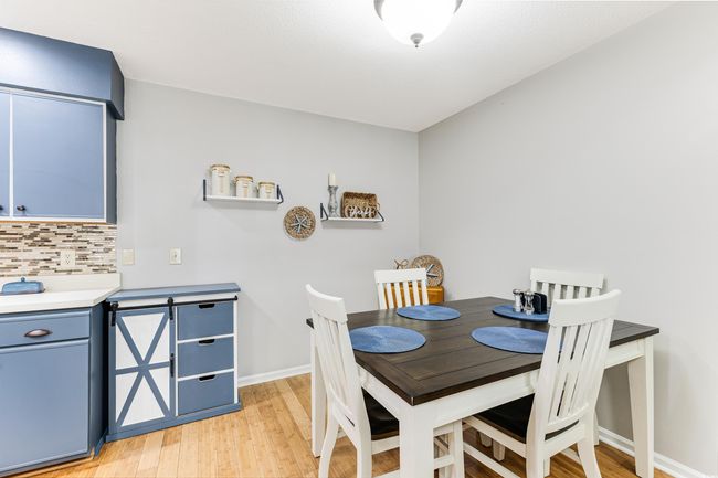 Dining area with light wood finished floors and baseboards | Image 6