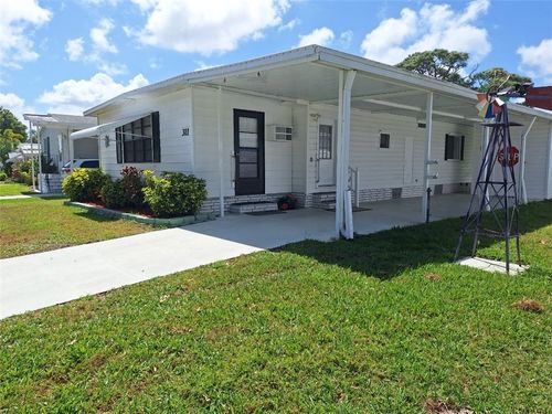 311 Egret Cir, Barefoot Bay, FL, 32976-7812 | Card Image