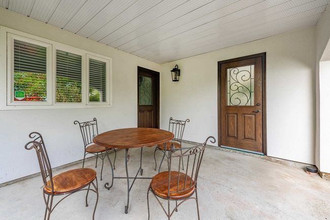 Dining room featuring unfinished concrete flooring | Image 22