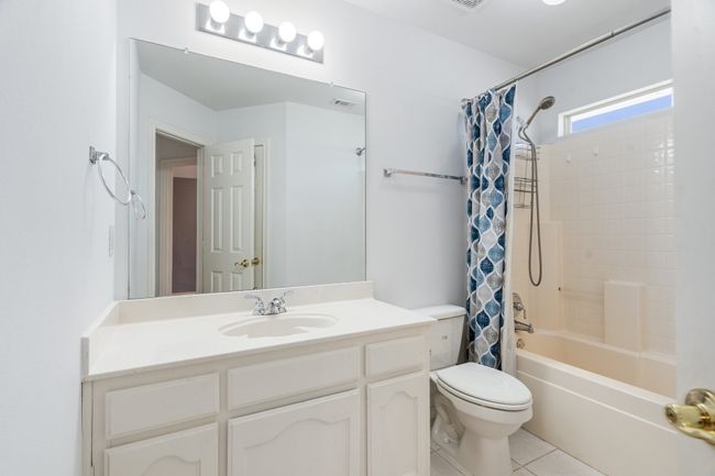 Full bath with vanity, tile patterned flooring, visible vents, toilet, and shower / tub combo | Image 21