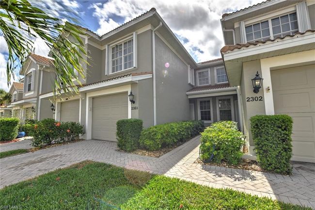 View of front of property featuring driveway, stucco siding, a tile roof, and a garage | Image 5